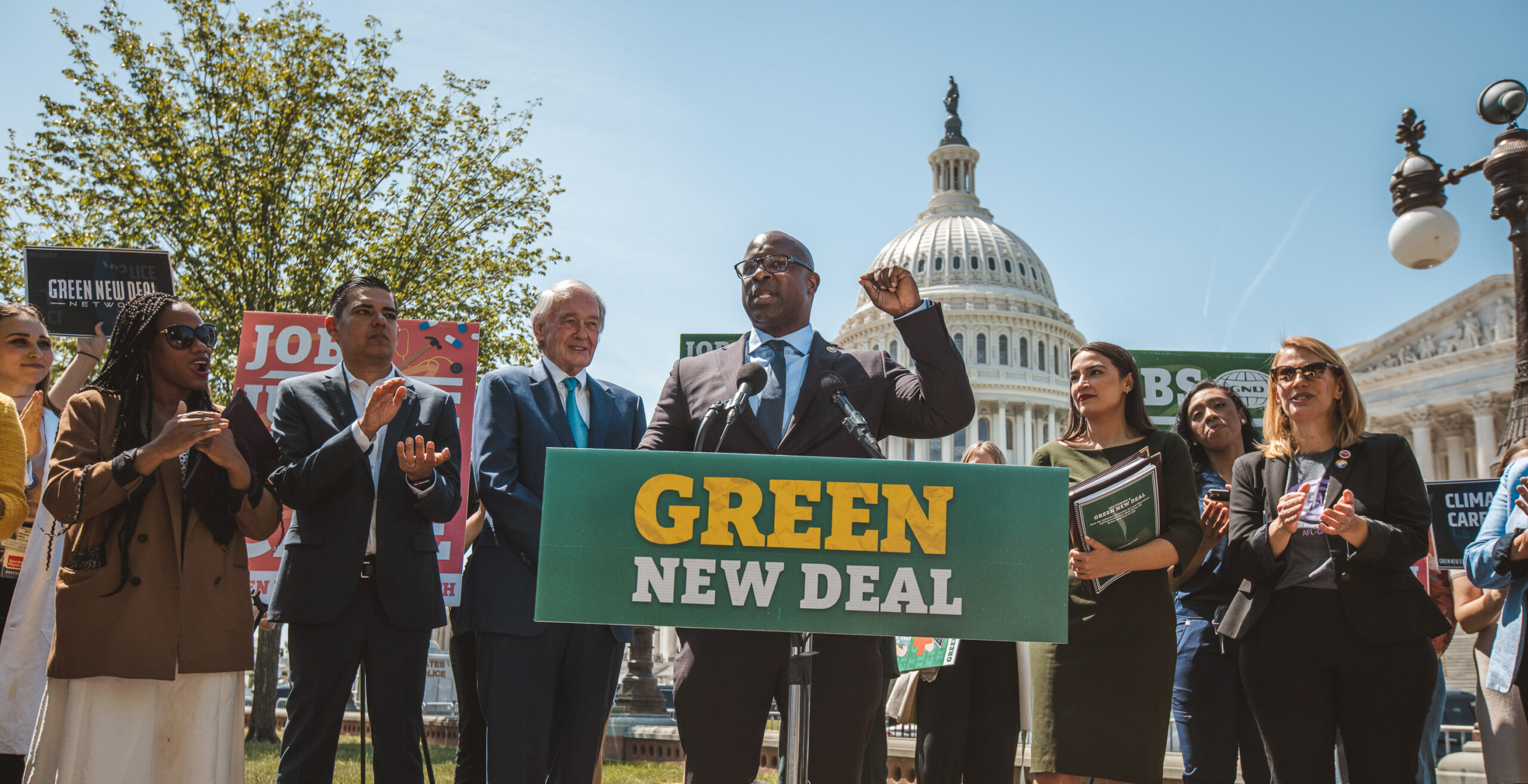 Congressional champions stand in front of the capitol after the reintroduction of the Green New Deal resolution